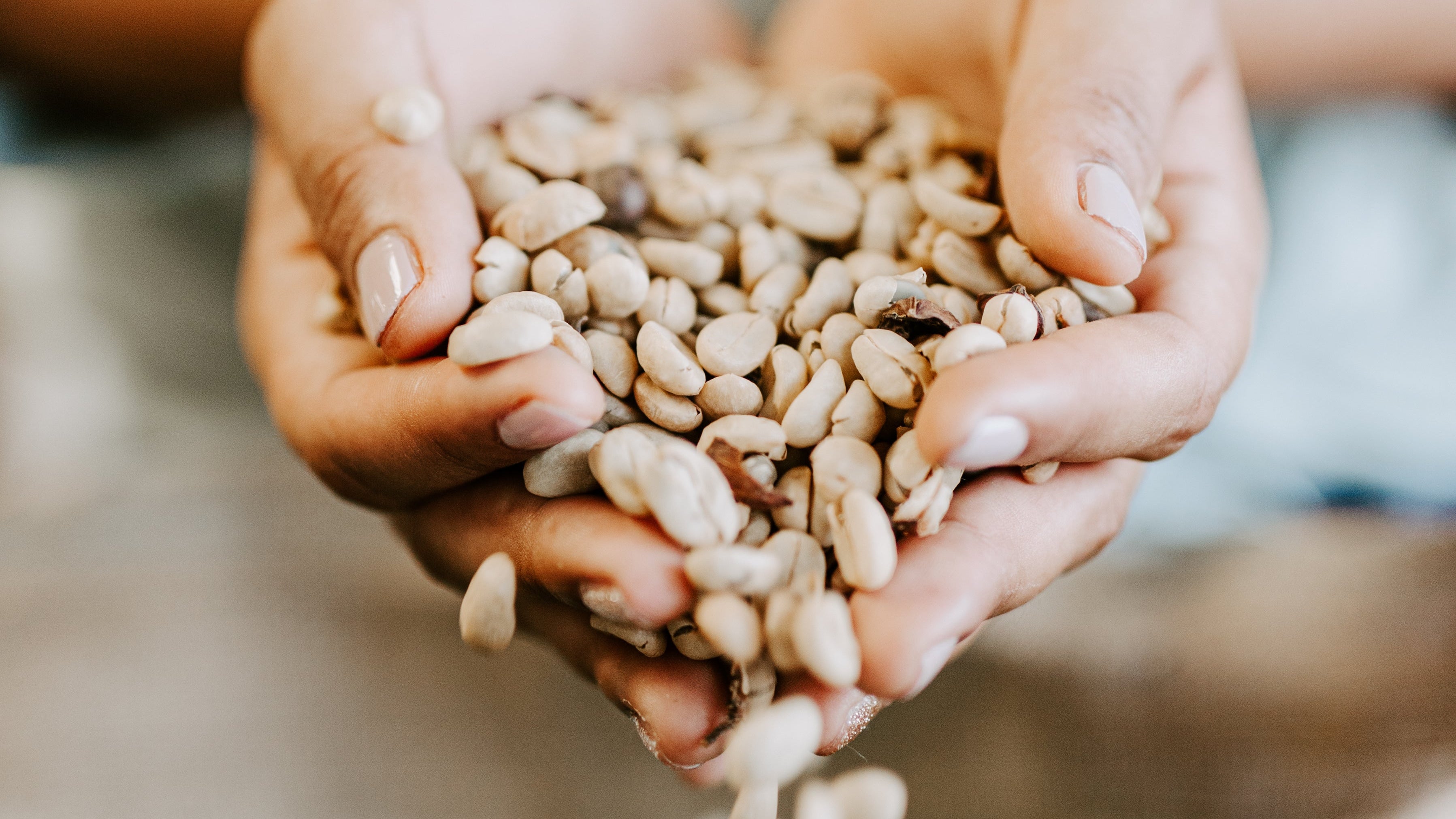 Victoria holding roasted coffee beans from Misma Lani, showcasing our 100% Kona coffee and the care behind every batch.